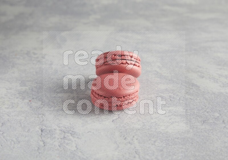 45º Shot of two Pink Raspberry macarons  on white  marble background