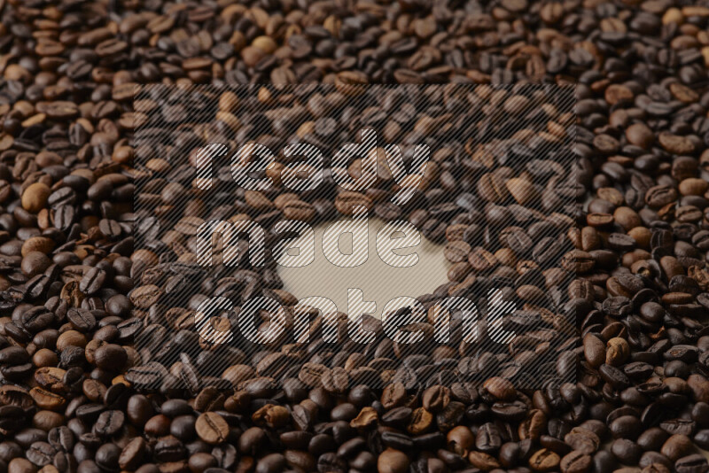 Roasted coffee beans on beige background