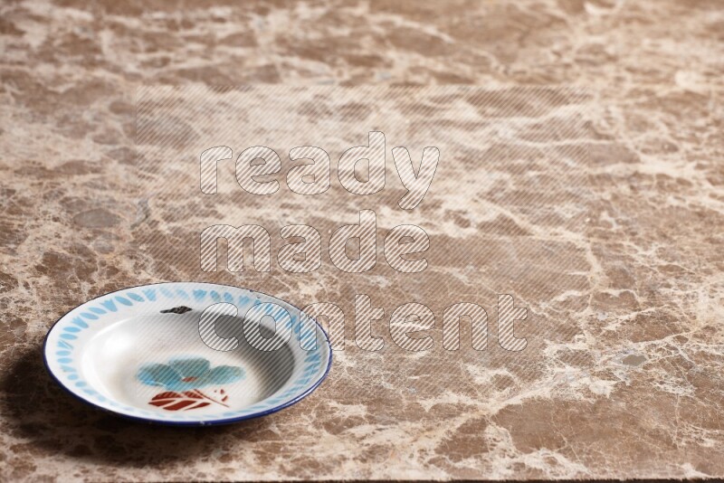A vintage metal plate on beige marble background