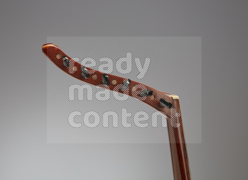 parts of a brown wooden Oud in a gray background