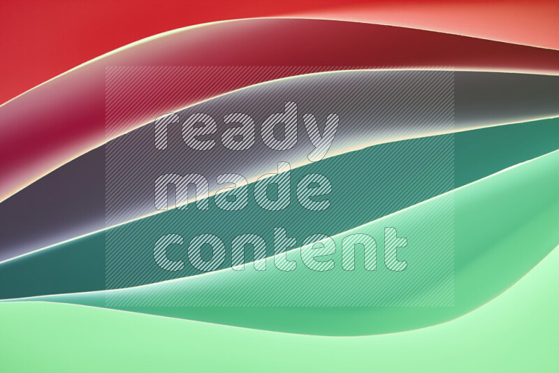 This image showcases an abstract paper art composition with paper curves in green and red gradients created by colored light