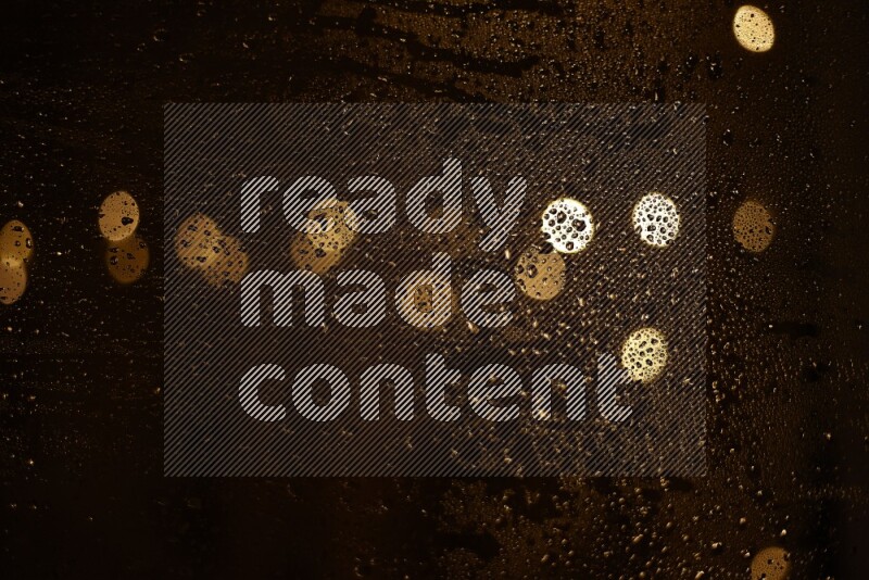 Bokeh light in yellow with water drops