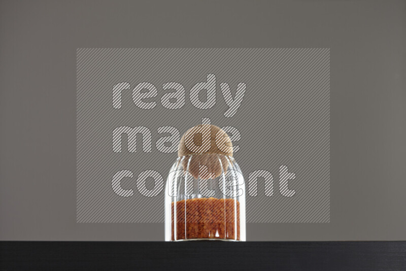Lentils in a glass jar on black background