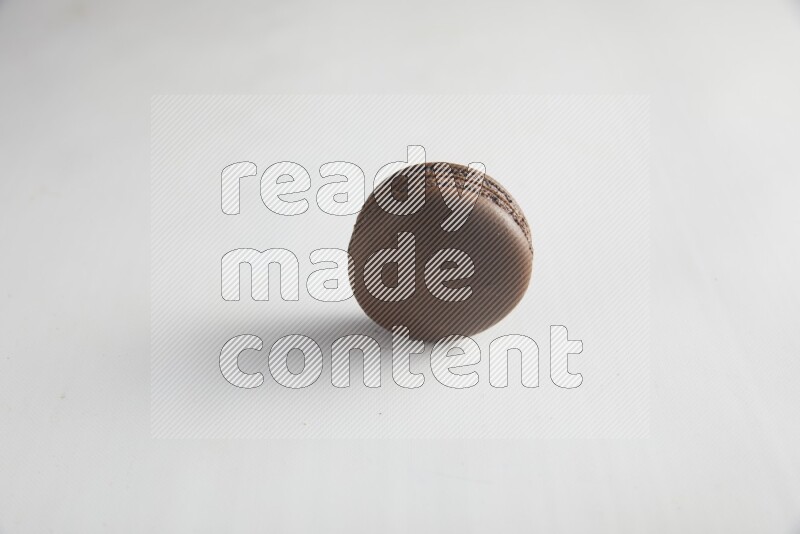 45º Shot of Brown Dark Chocolate macaron on white background