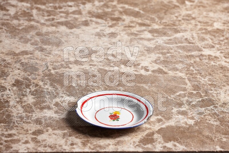 A vintage metal plate on beige marble background
