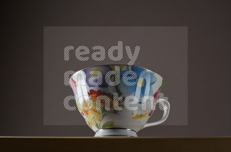 Low angle shot of a decorated cup on grey background