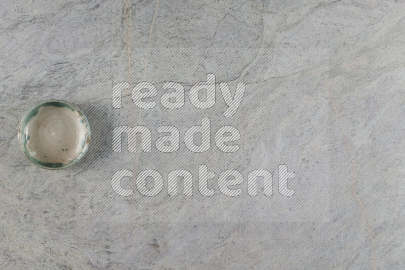 A multicolored pottery Bowl on grey marble background