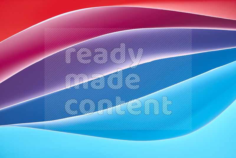 This image showcases an abstract paper art composition with paper curves in blue and red gradients created by colored light