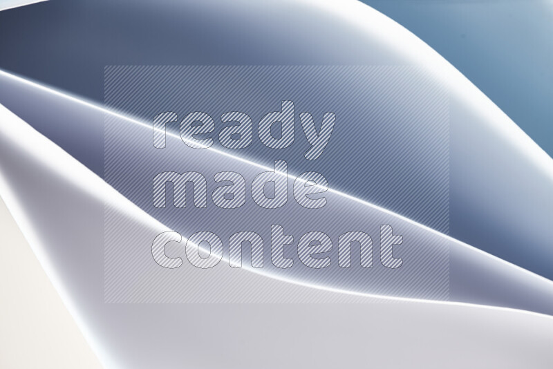 This image showcases an abstract paper art composition with paper curves in blue and white gradients created by colored light