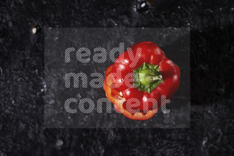 Red bell pepper slices on black background