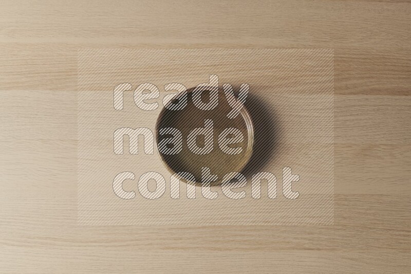 A multicolored pottery oven plate on light wooden background