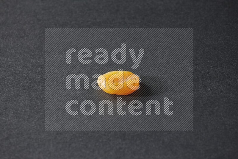 A dried apricot on a black background in different angles