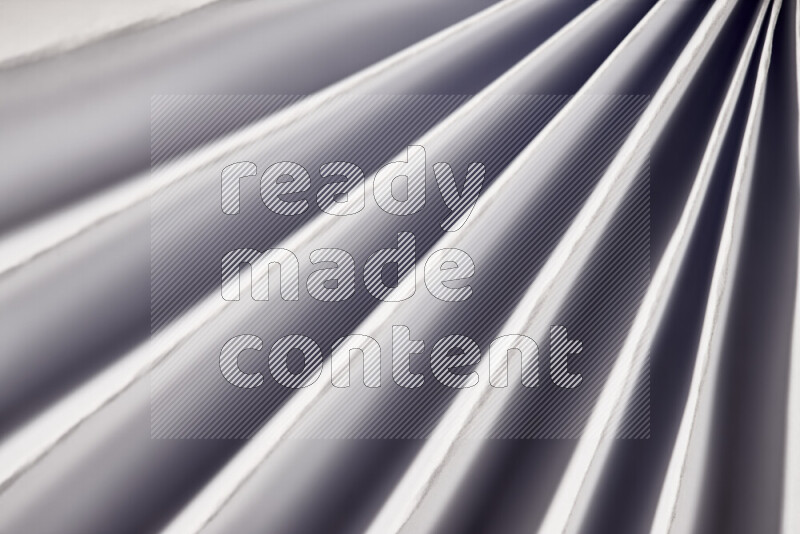 An image presenting an abstract paper pattern of lines in grey tones