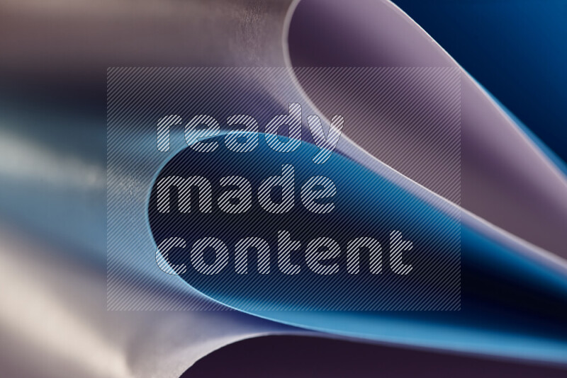 An abstract art showing purple and blue paper sheets arranged in an overlapping curves