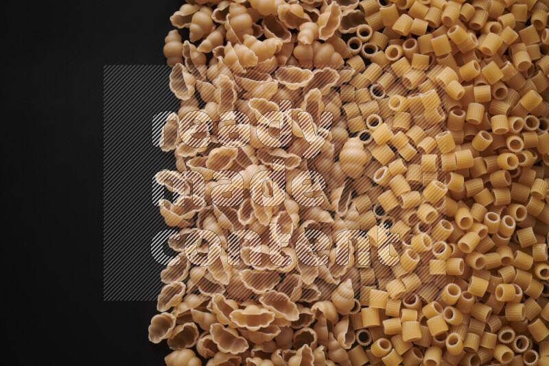 Different pasta types on black background