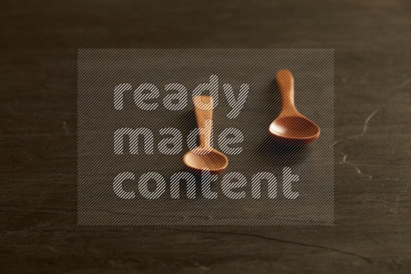 wooden spoon on black slate background