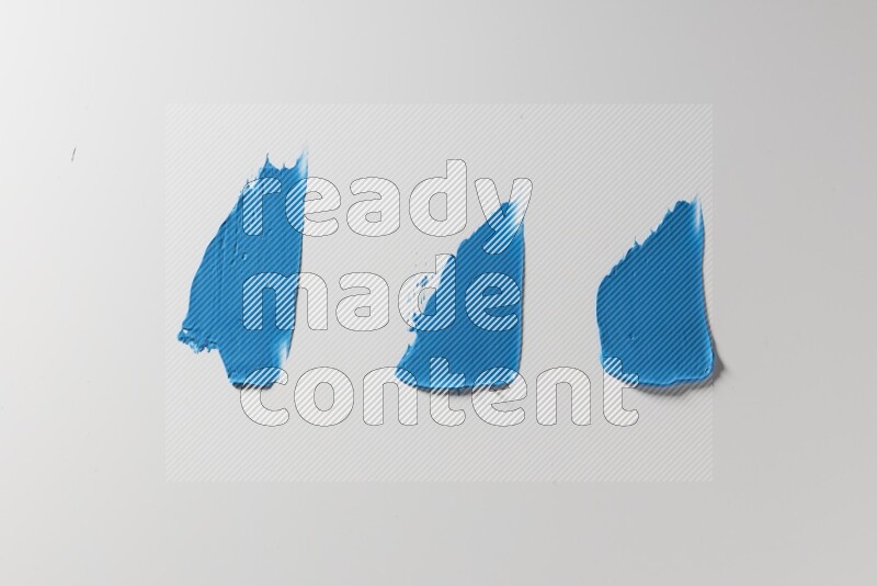 Blue painting knife strokes on a white background