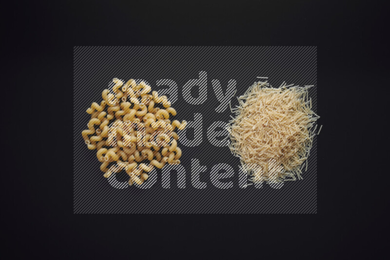 Different pasta types in bunches on black background