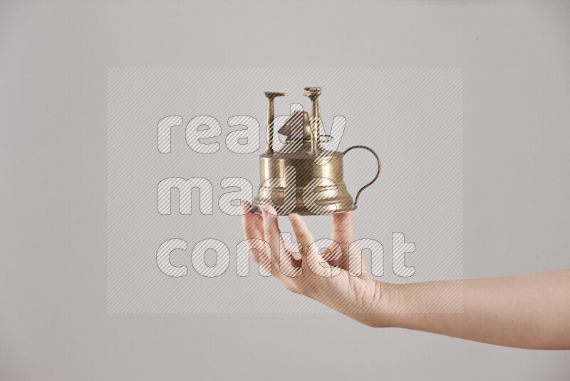 Woman hands holding different metal essentials in different positions