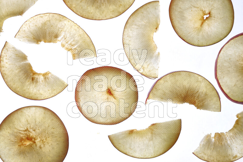 Peach slices on illuminated white background