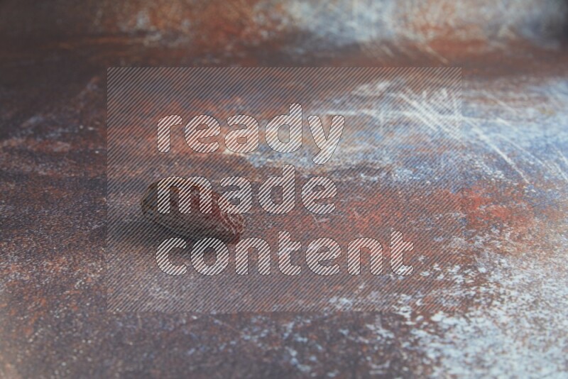 one madjoul date on a rustic reddish background