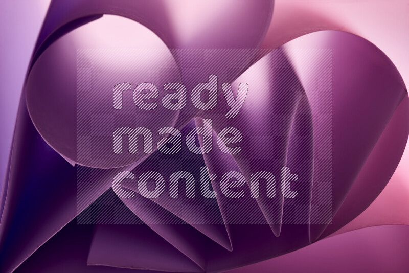 An artistic display of paper folds creating a harmonious blend of geometric shapes, highlighted by soft lighting in purple tones