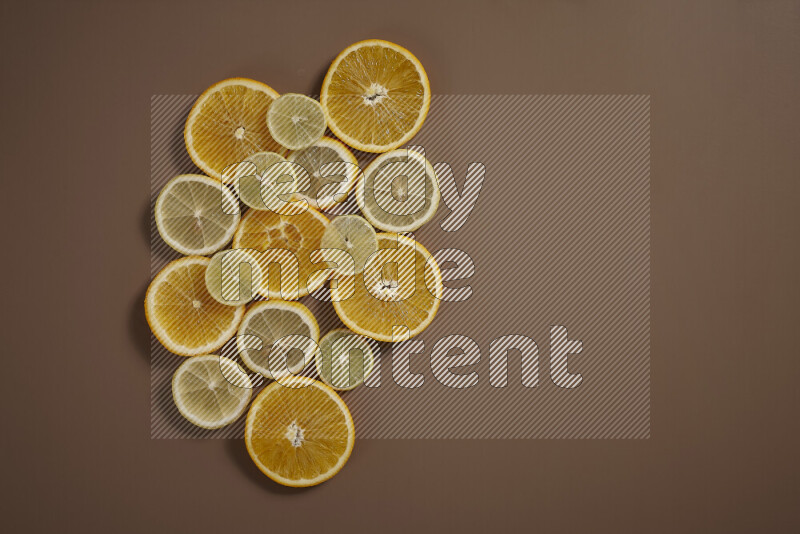 Some of citrus fruits such as lemon, lime and oranges lying on beige background