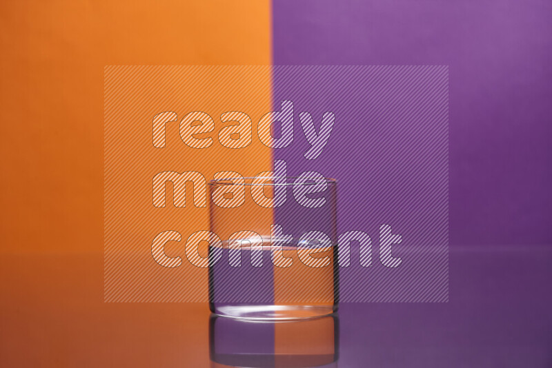 The image features a clear glassware filled with water, set against orange and purple background