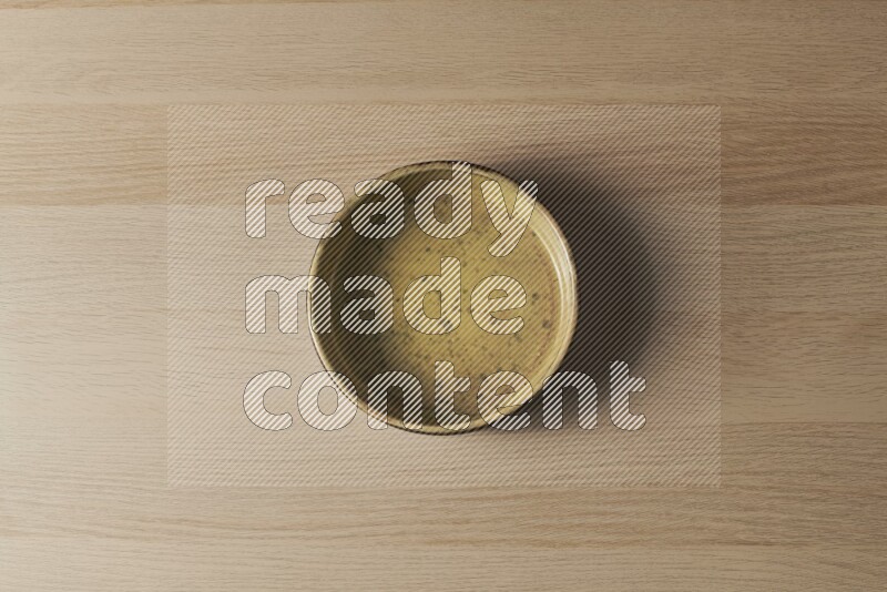 A multicolored pottery oven plate on light wooden background