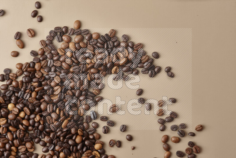 Roasted coffee beans on beige background