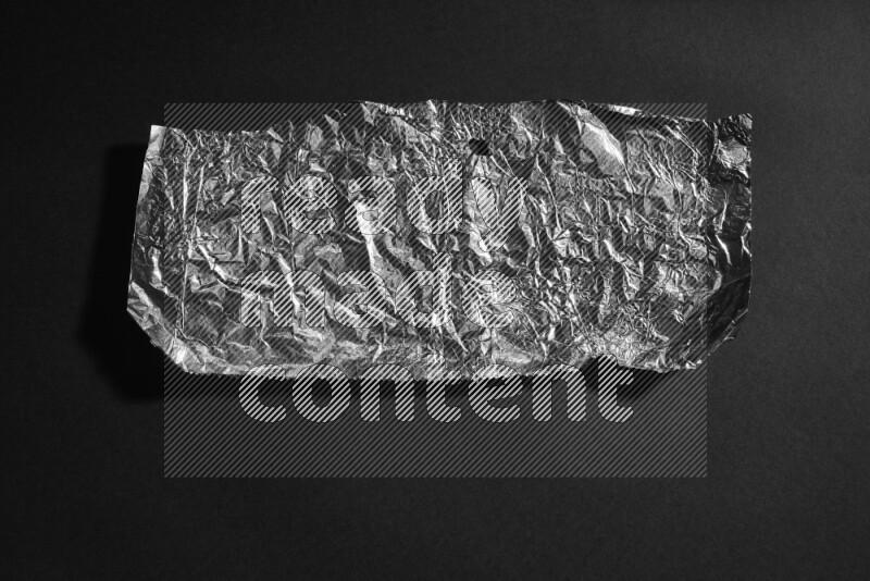 Aluminium foil on black background