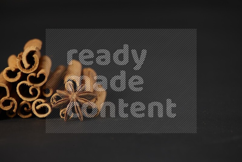 Cinnamon sticks and star anise on a black background