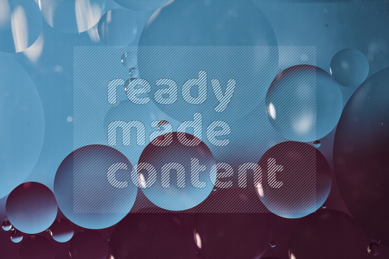 Close-ups of abstract oil bubbles on water surface in shades of blue and purple