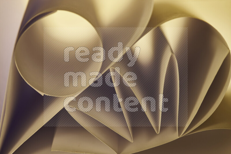 An artistic display of paper folds creating a harmonious blend of geometric shapes, highlighted by soft lighting in warm tones