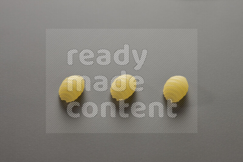 Shells pasta on grey background