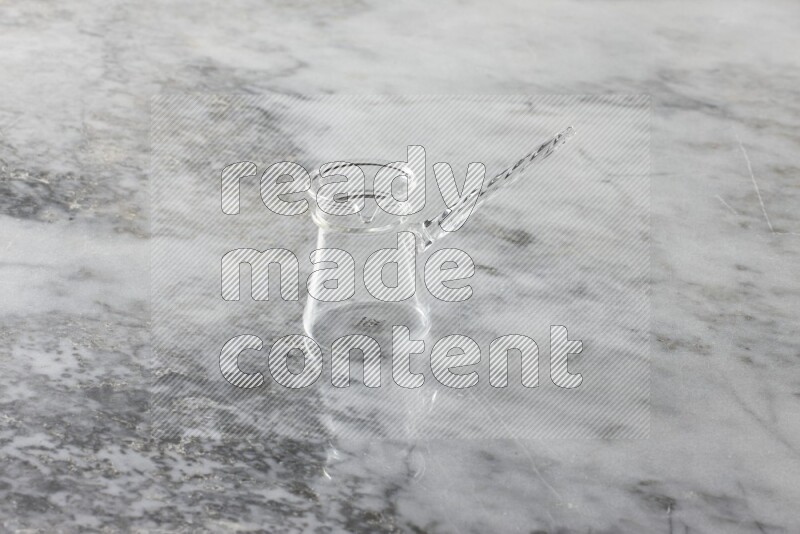 Glassware such as a coffee pot, a cup and a saucer on grey marble background
