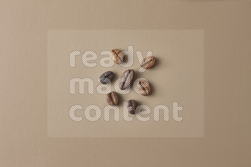 Roasted coffee beans on beige background
