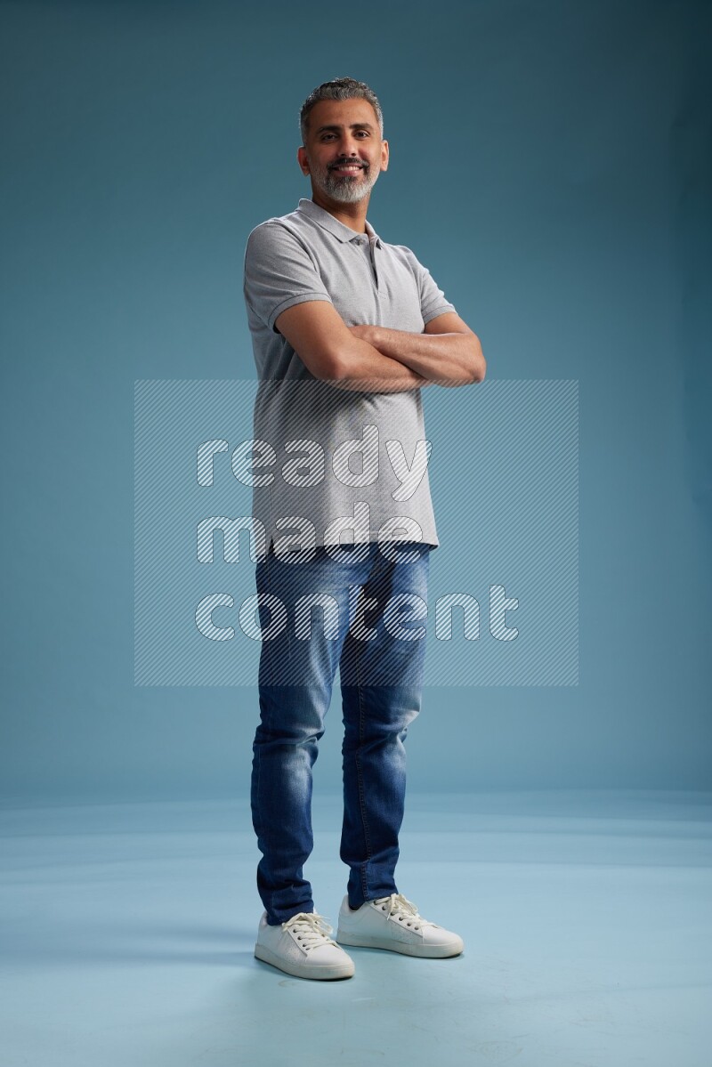 Man Standing Interacting with the camera on blue background