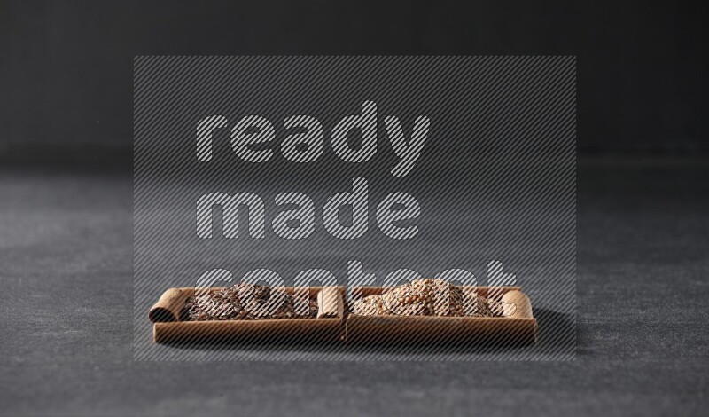 2 squares of cinnamon sticks full of mustard seeds and flaxseeds on black flooring