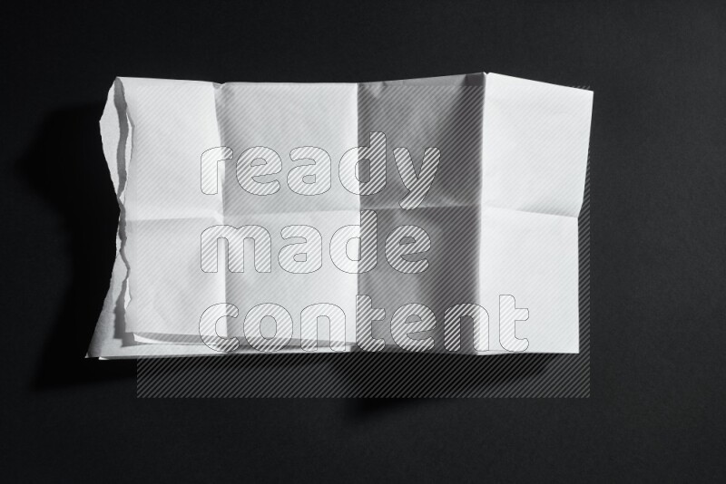 White paper sheet on black background