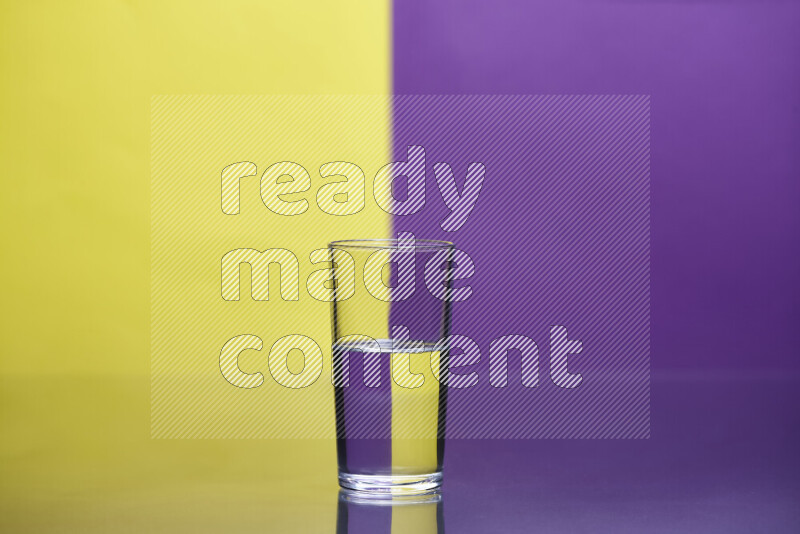 The image features a clear glassware filled with water, set against yellow and purple background