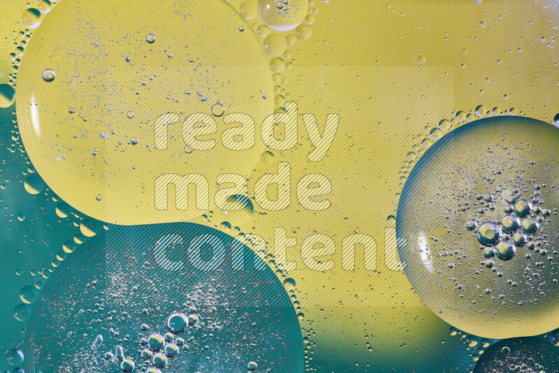 Close-ups of abstract oil bubbles on water surface in shades of green and yellow