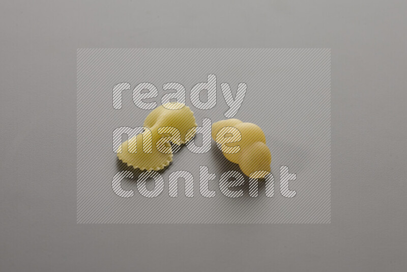 Fiocchi pasta with other types of pasta on grey background