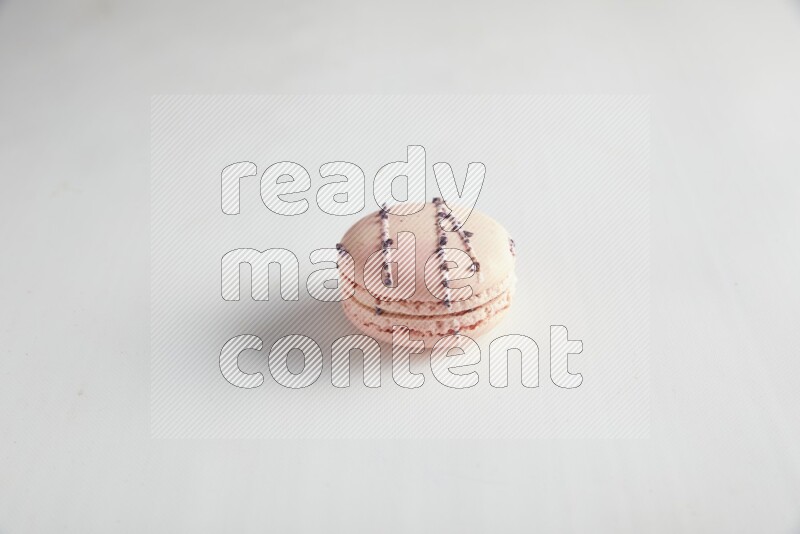 45º Shot of pink orange blossom macaron on white background