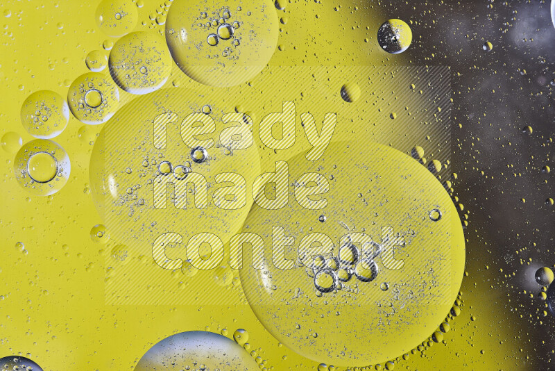 Close-ups of abstract oil bubbles on water surface in shades of yellow and brown