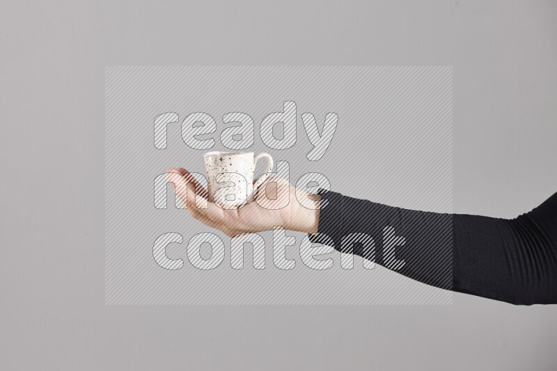 A woman in black abaya holding different pottery essentials in different positions
