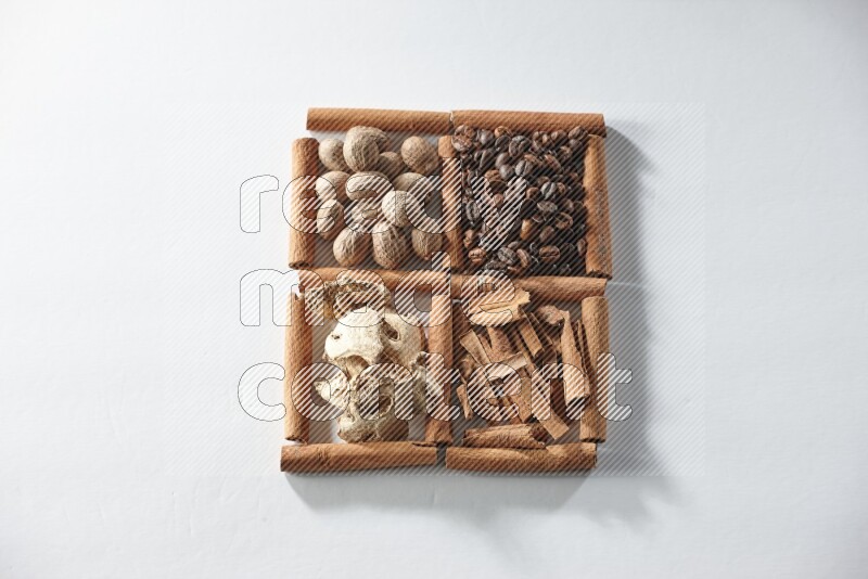4 squares of cinnamon sticks full of coffee beans, nutmeg, cinnamon and dried ginger on white flooring