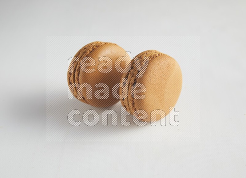 45º Shot of two Brown Maple Taffy macarons on white background