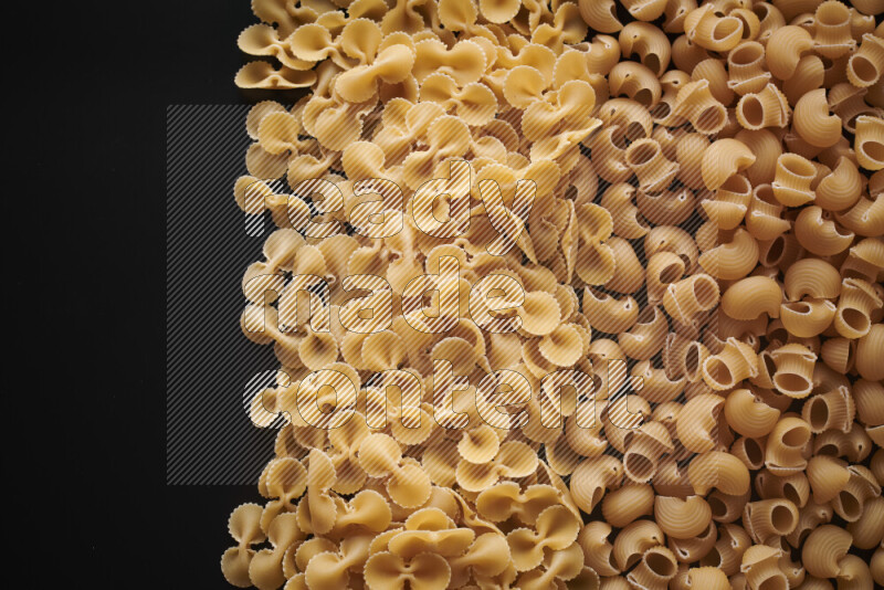 Different pasta types on black background