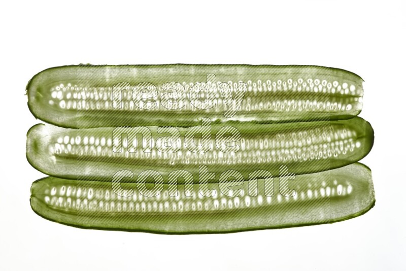 Cucumber slices on illuminated white background